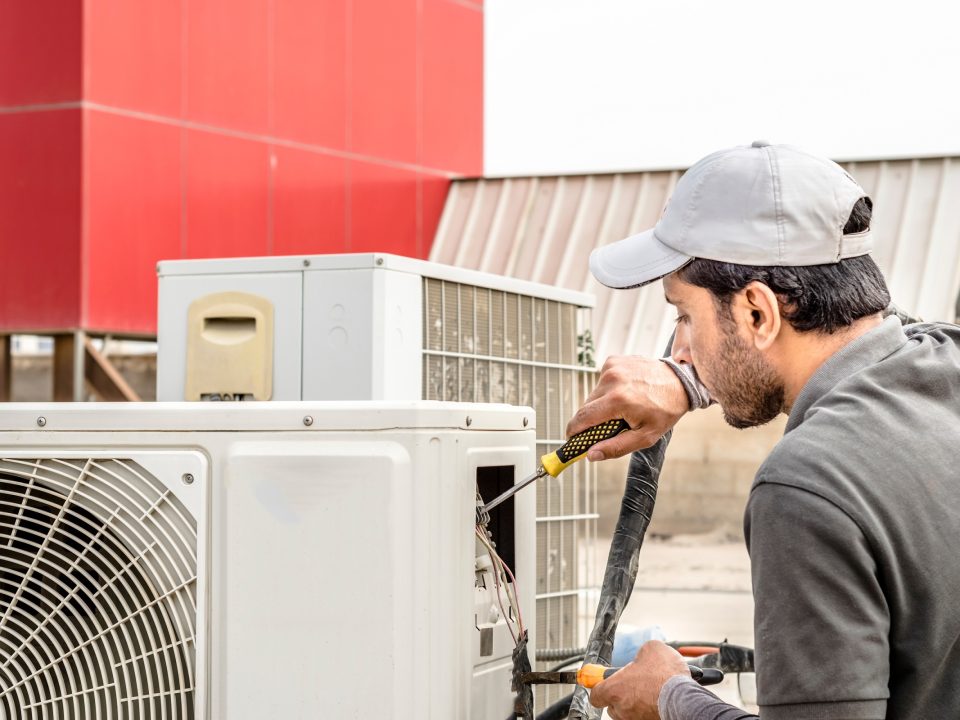 Tech repairing air conditioner